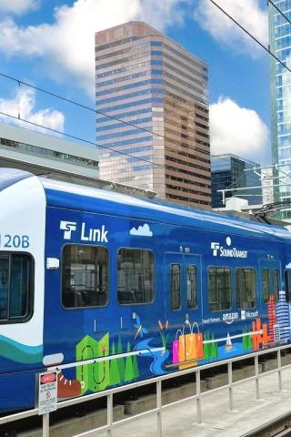 photo of Link 2 Line train in Bellevue with buildings in the background