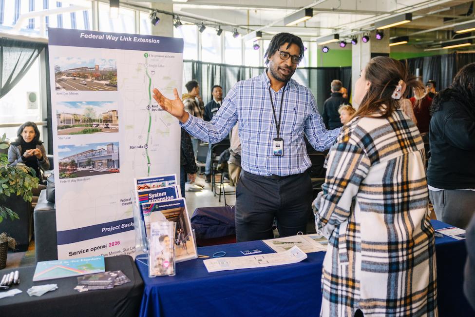 A Sound Transit employee speaks at a community outreach event.