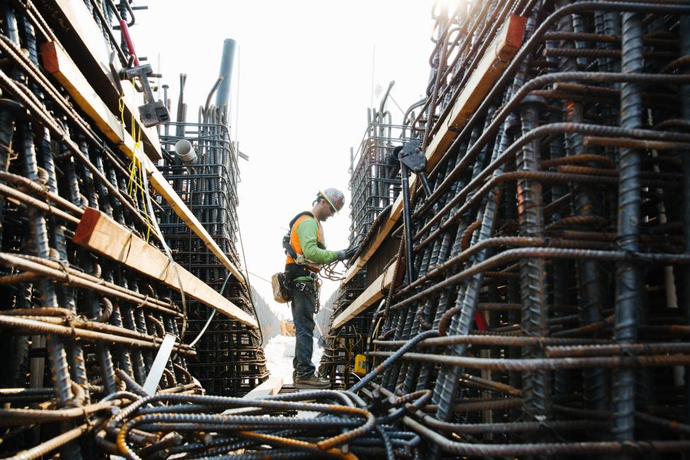 2018 in review: a worker wires rebar together for the new bridge over I-405. 