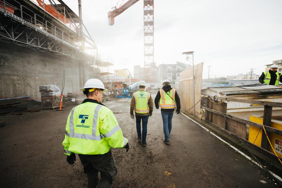 Workers walking on the Roosevelt Station construction site
