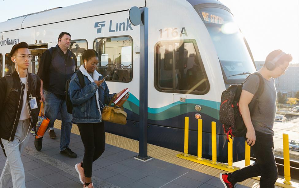 Riders board and exit a Link light rail train.