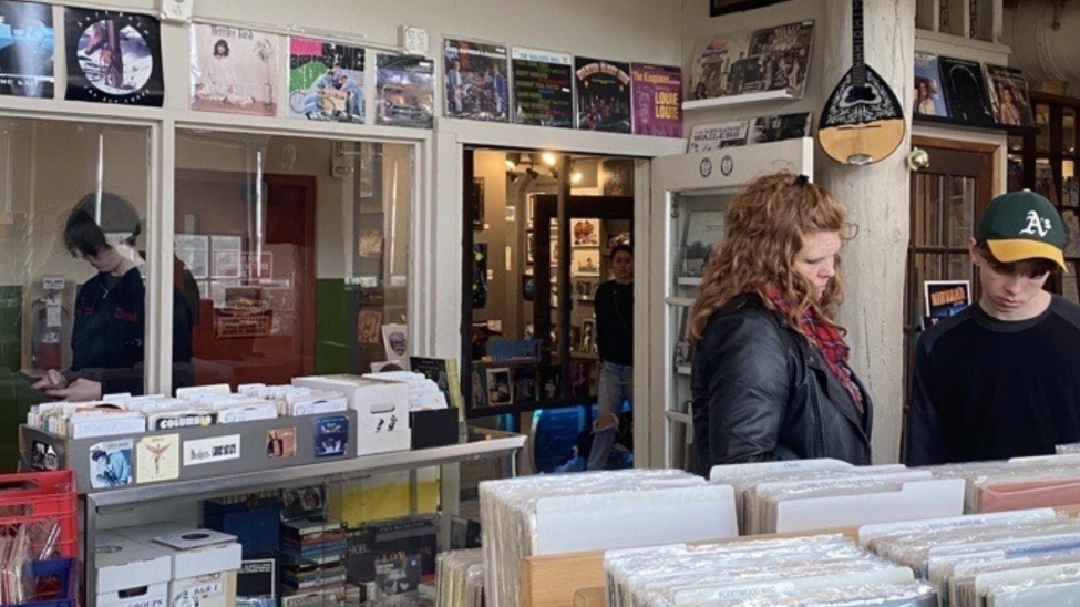 People browse the selection of vinyl at Holy Cow Records