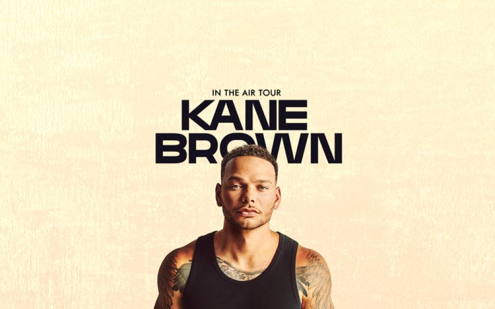 Kane Brown's promotional poster for his In the Air tour featuring him standing in front of a tan background