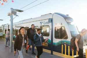 Tacoma Dome Link Extension project update header, image of riders exiting the train