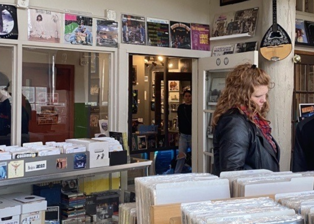 People browse the selection of vinyl at Holy Cow Records